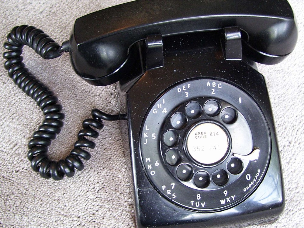A black Western Electric Model 500 rotary desk telephone with its circular dial