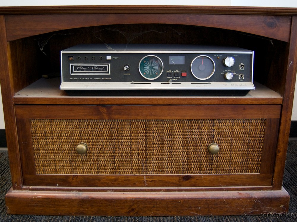 An Electrophonic 8-track tape player and radio receiver in a wooden cabinet