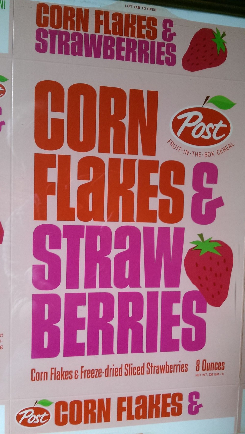 An unfolded Post Corn Flakes & Strawberries cereal box in pink and orange, reading Corn Flakes and Freeze-dried Sliced Strawberries, 8 ounces
