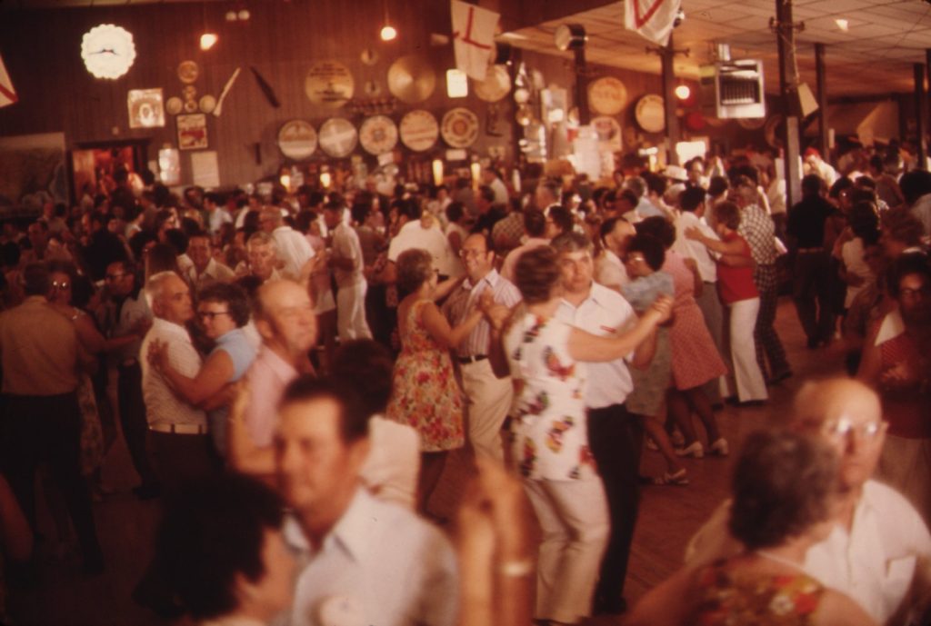 A crowded ballroom floor of couples dancing the polka at the Gibbon Ballroom in Minnesota in July 1974