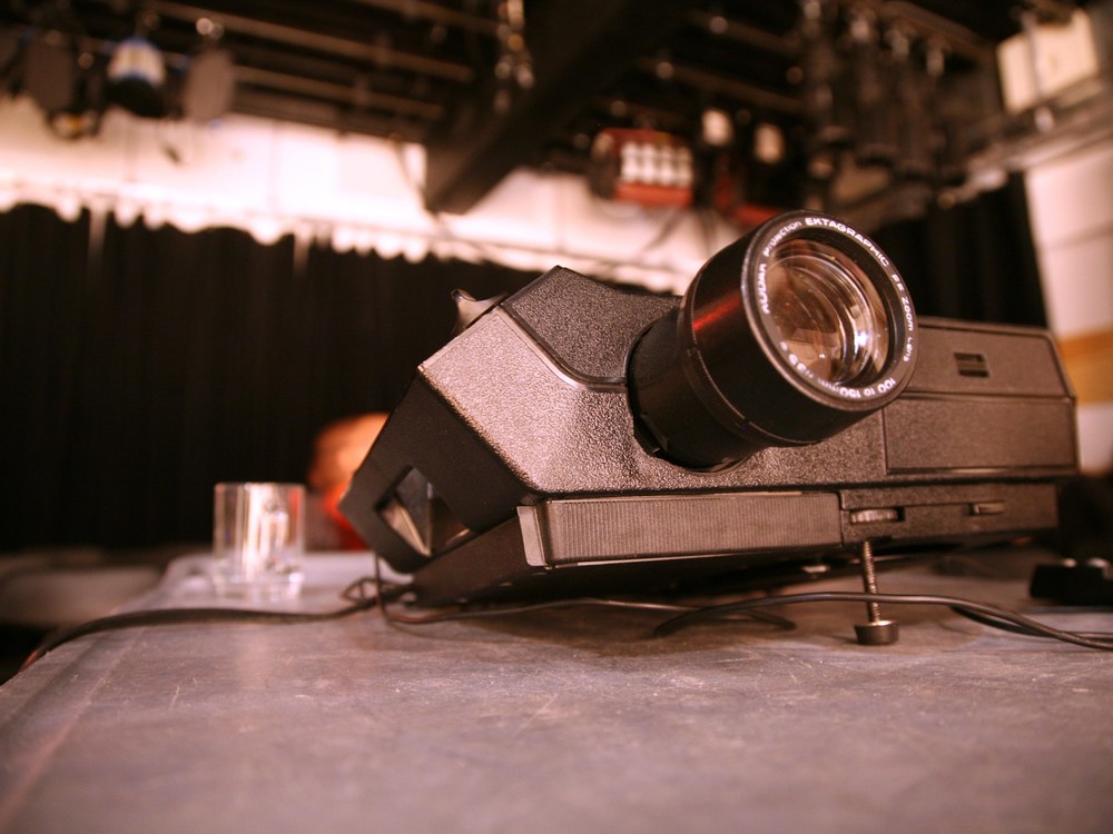 A black Kodak Carousel slide projector with its projection lens facing the camera
