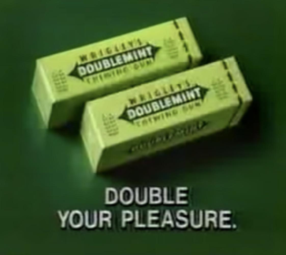 Two green packs of Wrigley’s Doublemint gum above the words Double your pleasure