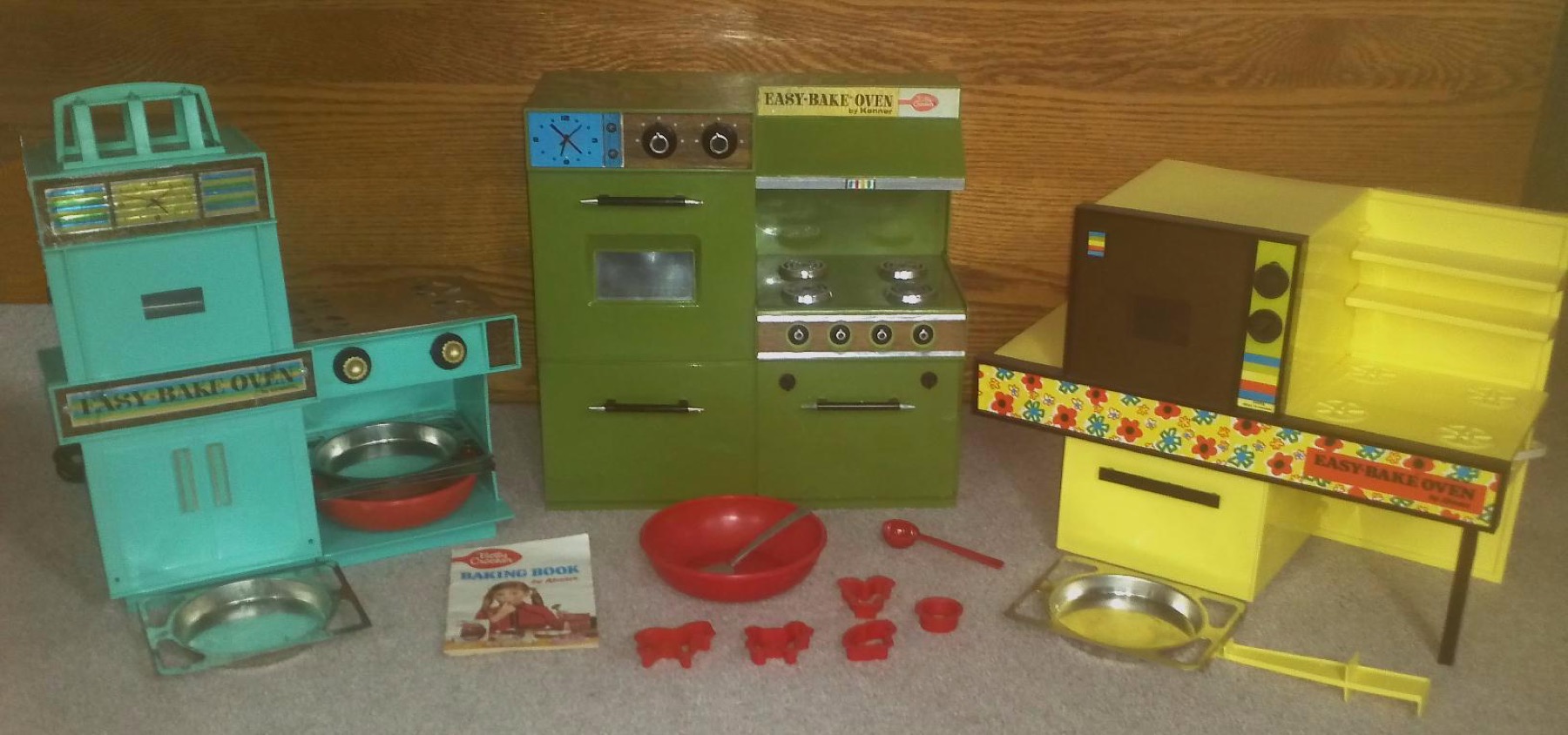 Three early Easy-Bake Ovens from 1963, 1969, and 1971 with pans and utensils