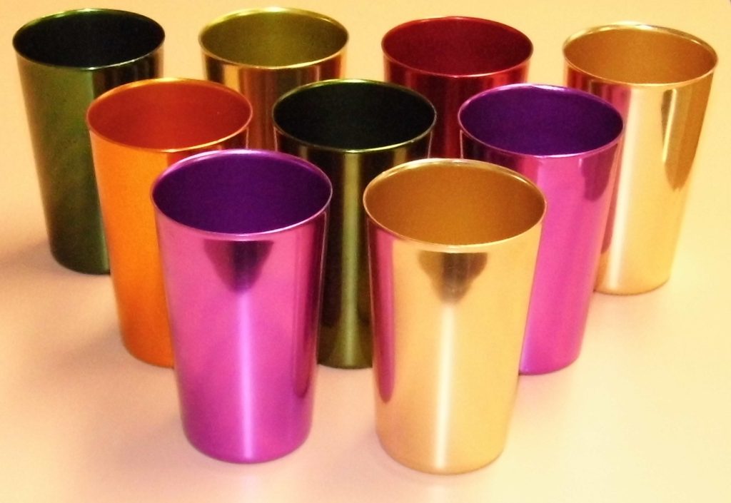 Nine shiny anodized aluminum tumblers in green, gold, red, orange, purple and pink, arranged in rows